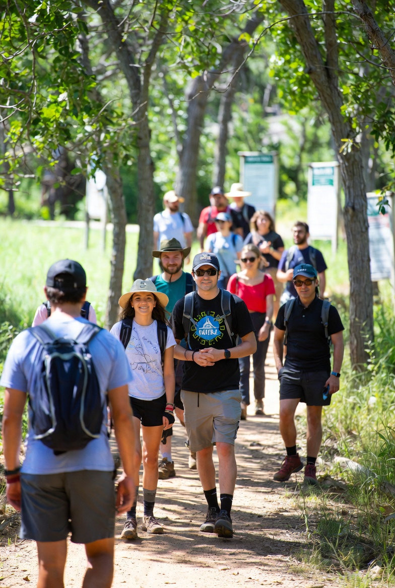 Cyclists on a newly opened resilient trail network, secured through Conservation United's innovative bonding solutions